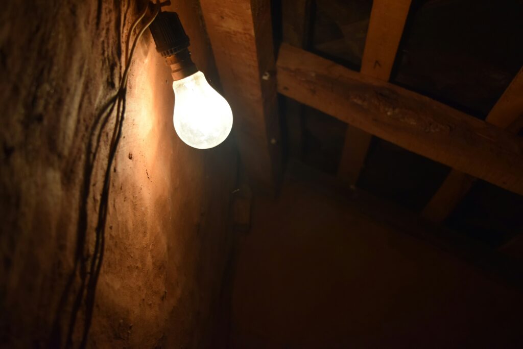 If you're experiencing flickering lights and visible wiring issues in a rustic room, it may be time to call a professional electrician. For expert electrical services in Vancouver, WA, contact us to ensure a safe and properly lit space.