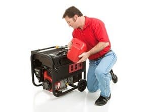 A man filling a backup generator with gasoline